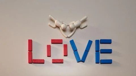 Colorful array of plastic blocks arranged to spell out the word 'love' with two Stock-Fotos