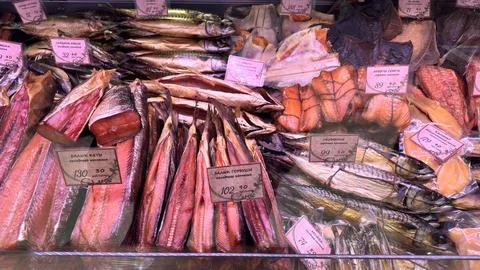 Colorful array of smoked fish display at seafood market. Stock Photos
