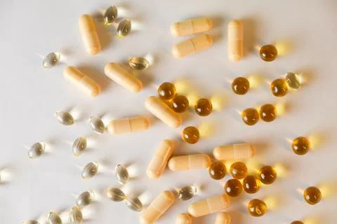 Colorful array of supplements spread across a clean surface Stock Photos