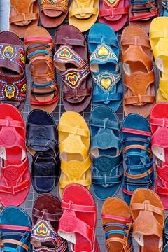 Colorful Array of Traditional Handcrafted Leather Sandals on a Market Display Stock Photos