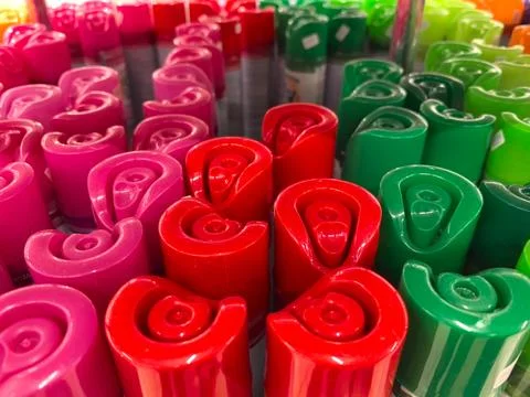 Colorful array of vibrant caps in a creative workspace setting Stock Photos