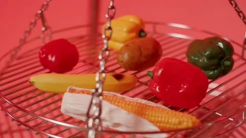 Colorful Artificial Fruit and Vegetables on Metal Rack, Red Studio, Static Shot Видео 341516155