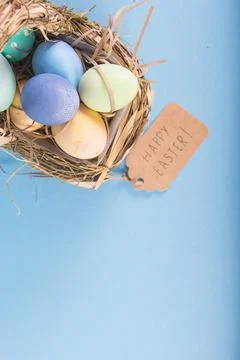 Colorful background with Easter eggs on blue background. Happy Easter concept Stock Photos