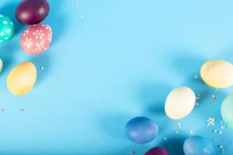 Colorful background with Easter eggs on blue background. Happy Easter concept Stock Photos