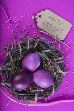 Colorful background with Easter eggs on lavender background. Happy Easter con Stock Photos
