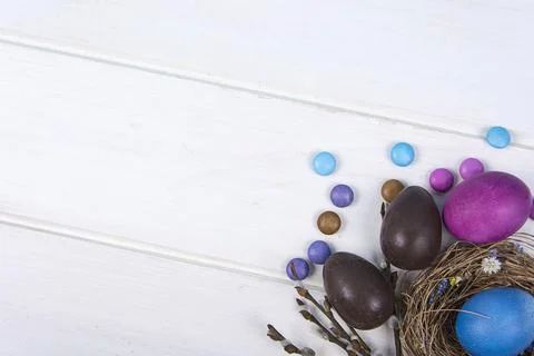 Colorful background with Easter eggs on white wooden board background. Happy  Stock Photos