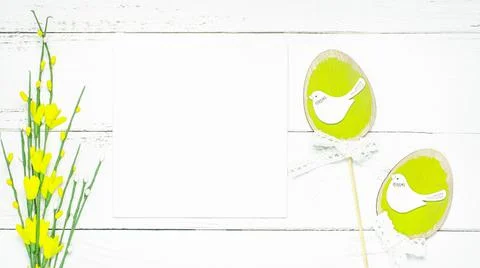 Colorful background with Easter eggs on white wooden board background. Stock Photos