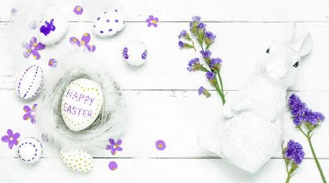Colorful background with Easter eggs on white wooden board background. Stock Photos