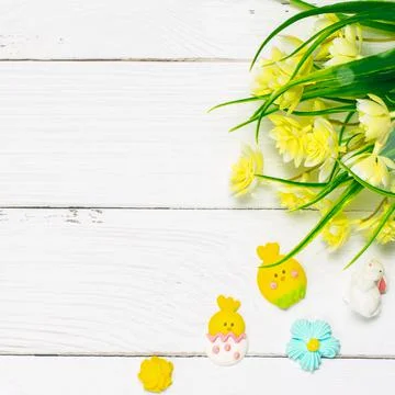 Colorful background with Easter eggs on white wooden board background. Stock Photos