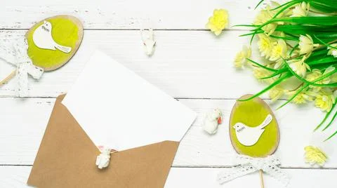 Colorful background with Easter eggs on white wooden board background. Stock Photos