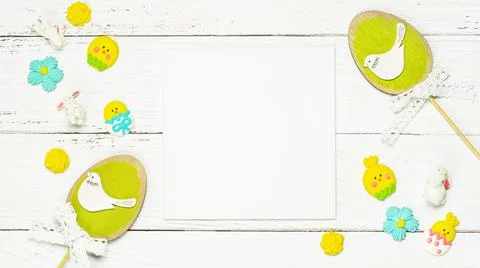 Colorful background with Easter eggs on white wooden board background. Stock Photos