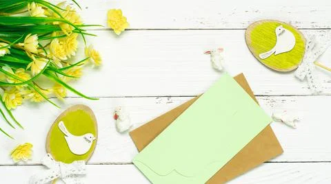 Colorful background with Easter eggs on white wooden board background. Stock Photos