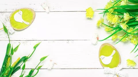 Colorful background with Easter eggs on white wooden board background. Stock Photos