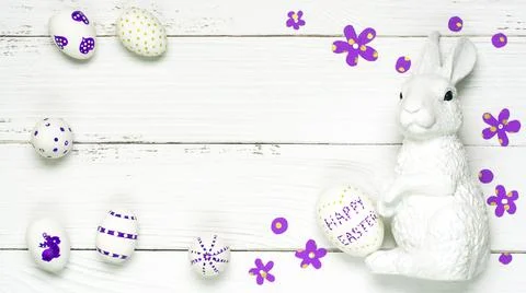 Colorful background with Easter eggs on white wooden board background. Stock Photos