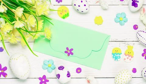 Colorful background with Easter eggs on white wooden board background. Stock Photos