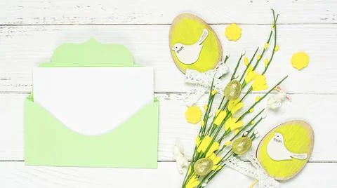 Colorful background with Easter eggs on white wooden board background. Stock Photos