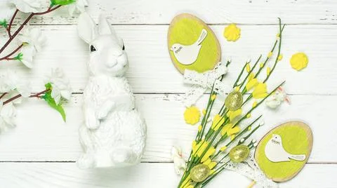 Colorful background with Easter eggs on white wooden board background. Stock Photos