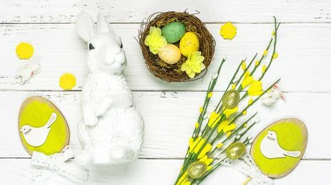 Colorful background with Easter eggs on white wooden board background. Stock Photos