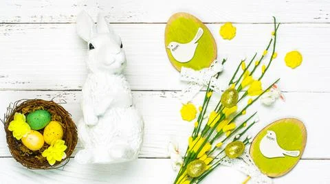 Colorful background with Easter eggs on white wooden board background. Stock Photos