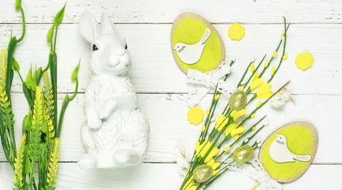 Colorful background with Easter eggs on white wooden board background. Stock Photos
