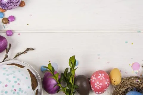 Colorful background with Easter eggs on white wooden board background. Happ.. Stock Photos