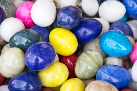 Colorful background of eastern stone eggs. Stock Photos