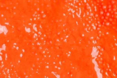Colorful background - textured orange wet plasticine - irregular pattern Stock Photos