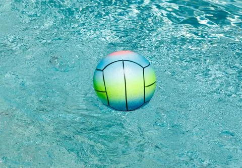A colorful ball is floating in a pool Stock Photos