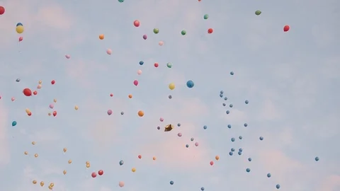 Colorful balloons are flying in the sky. People release balloons. Stock Footage