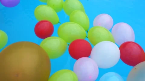 Colorful balloons float in the pool Stock Footage 200932474