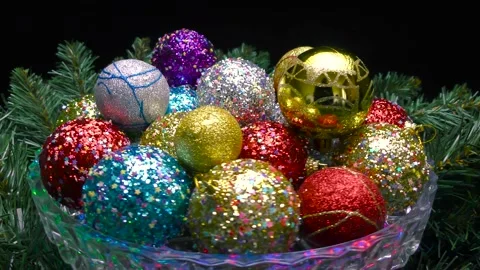 Colorful balls with patterns rotate over the Christmas tree branches Stock Footage 165047457