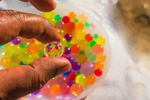Colorful balls reflection in hydrogel ball. Stock Photos