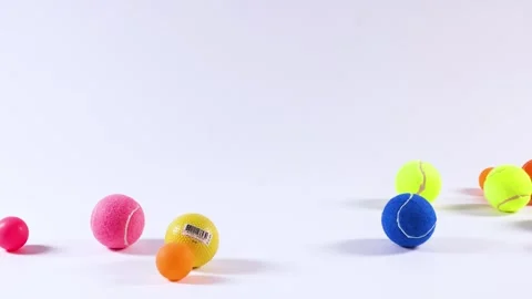 Colorful Balls Rolling on White Surface Stockbeeldmateriaal 310163791