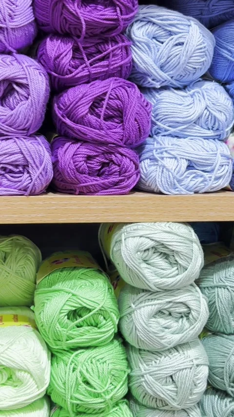 Colorful balls of wool on the shelf. Different balls of yarn of different colors Stock Footage 250385891