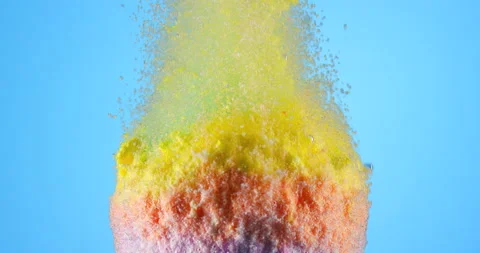Colorful bath bomb falling down into clean water against blue background. Filmed Stock Footage 151854484