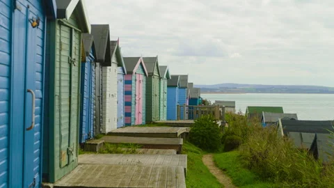 Colorful beach huts on the cliffs in England Stock-Footage 240634851