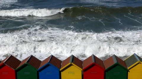 Colorful beach huts with surf Stock Footage 64384352