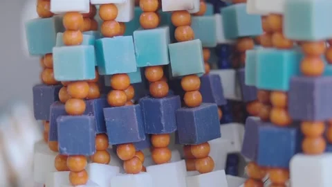 Colorful beads create patterns in a craft space Stock Footage 336038349