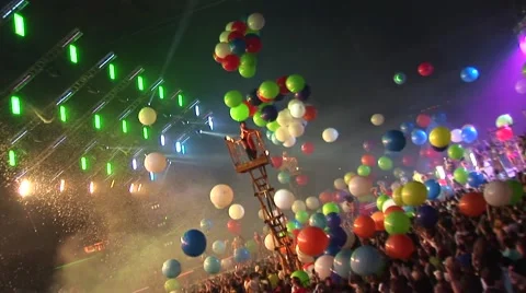 Colorful big balloons fall to the crowd at a concert. Stock Footage 48156264