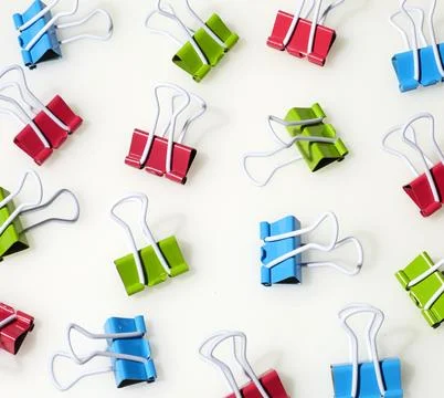Colorful Binder Clips Pattern on White Background Stock Photos