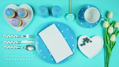 Colorful blue theme breakfast brunch table setting flatlay stop motion. Stock Footage 112911573