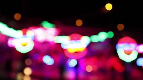 Colorful blurry blinking lights of a carousel ride at night Stock Footage 154649200