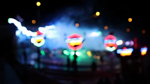 Colorful blurry lights of carousel ride with artificial fog Stock Footage 120138372