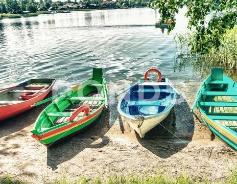 Colorful boats on lake shore Stock Photos