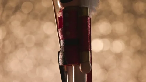 Colorful bokeh studio backdrop highlights a spinning Toy Nutcracker, finishing Stock Footage 321680985