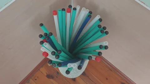 Colorful boomwhackers, plastic percussion tubes, slowly rotating in a basket Video stock 344816109