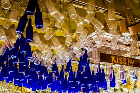 Colorful bottles hanging from ceiling, from below. Stock Photos