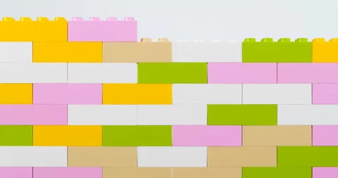 Colorful bricks making wall on white background Video stock 127051879