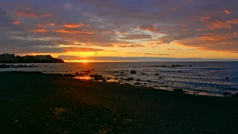Colorful bright dramatic sunset, dawn on the ocean. The sun rises from beyond Stock Footage 121141400