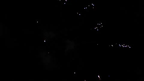 Colorful bright fireworks exploding in the air at night and leaving the smoke Stock Footage 133026657